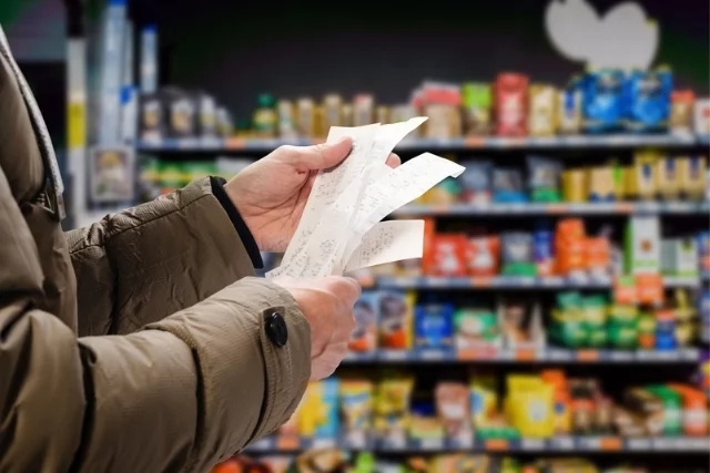 A person looks at their rising food bill in a supermarket