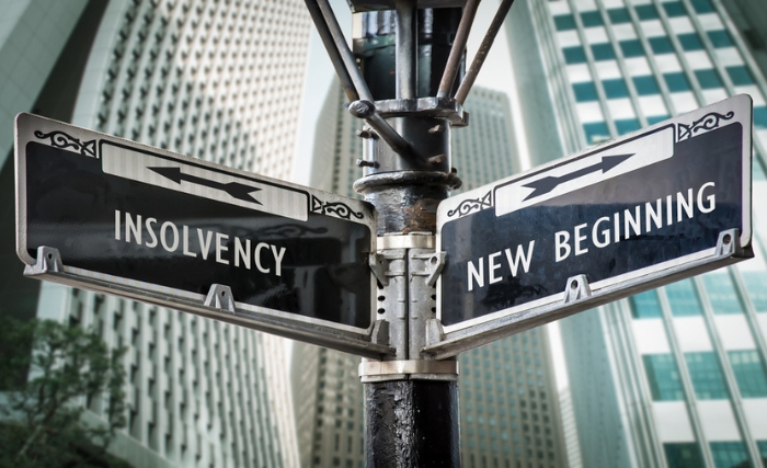 a signpost pointing between insolvency and a new beginning