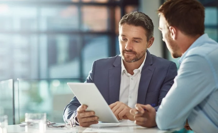 Two business-dressed men having an insolvency meeting