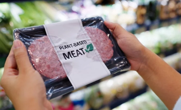 Someone holding plant based burgers