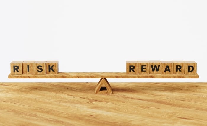 A pair of scales reading risk vs reward