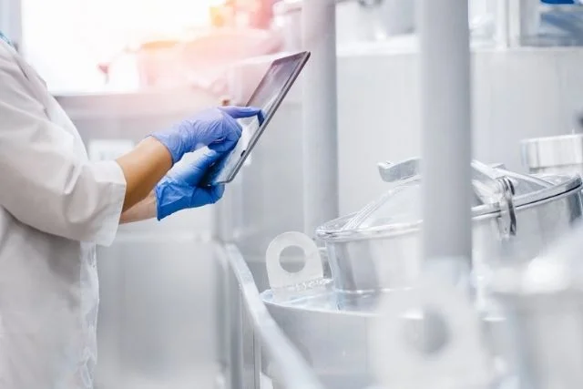 Someone inspecting equipment in a factory or lab