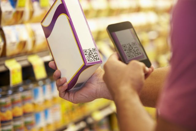 Someone scans a QR code on the side of a food package with their phone