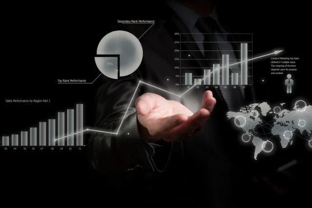 Holding a hand out against computer graphic created pie charts and graphs