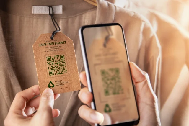 Someone using a QR code to buy a recycled shirt representing corporate social responsibility